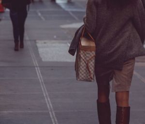 Low section of people walking on road