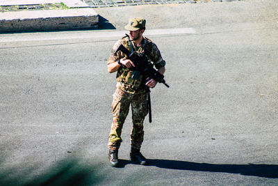 Full length of senior woman standing on road