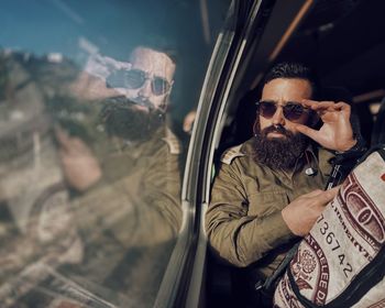 Midsection of man sitting in car