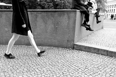 Low section of woman walking on zebra crossing