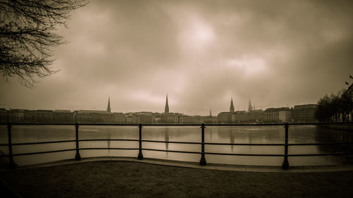 Railing against cloudy sky