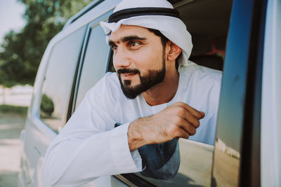 Man looking at camera while sitting in car