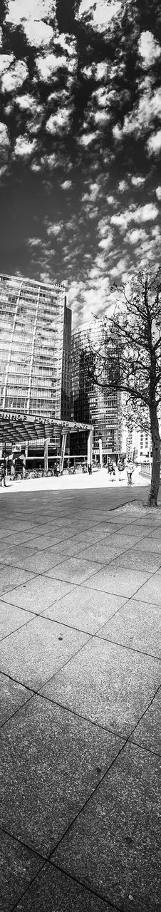 built structure, architecture, building exterior, day, outdoors, water, sunlight, tree, street, city, shadow, sky, railing, metal, no people, absence, transportation, park - man made space, nature, river