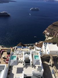 High angle view of sea by city against sky