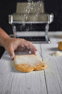 Low section of person washing hands on table