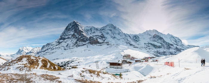 Scenic view of snow covered mountains against sky