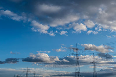 Low angle view of electricity pylon against sky