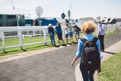 Rear view of people walking outdoors