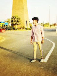 Full length of boy standing on road