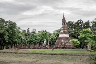 View of temple building against cloudy sky