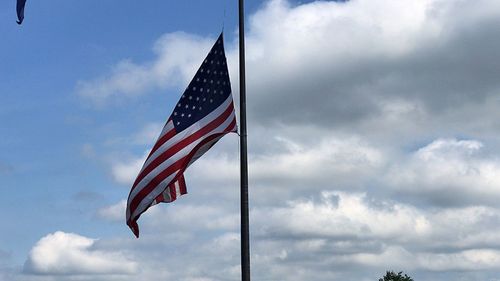 Low angle view of flag flags against sky