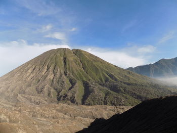 Scenic view of volcanic mountain against sky