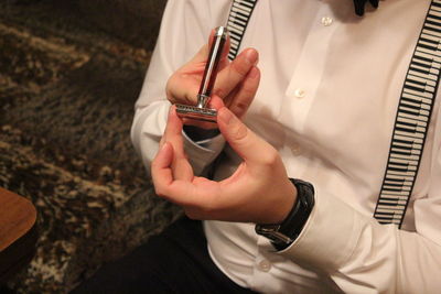 Close-up of man holding a classic razor 