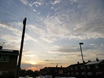 Low angle view of buildings against sky during sunset