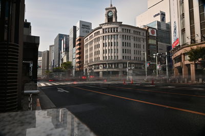 View of city street and buildings against sky