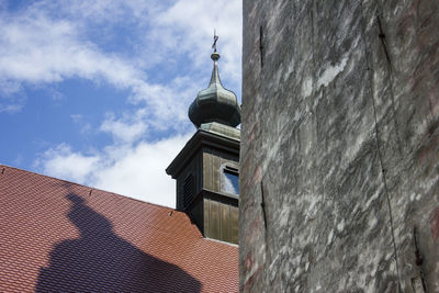 Low angle view of bell tower against sky