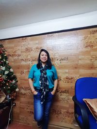 Portrait of smiling young woman standing at home