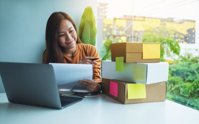 Young woman using laptop on table
