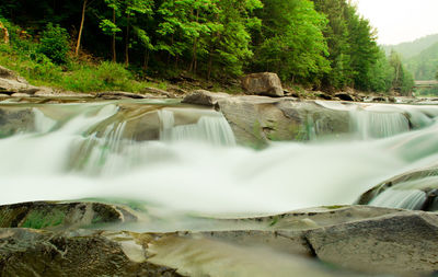 Scenic view of river flowing through rocks