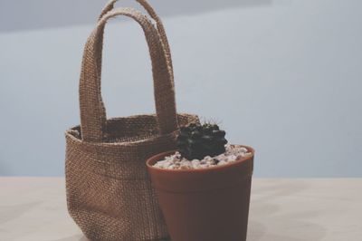 Close-up of strawberry in basket on table against wall