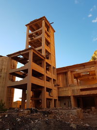 Low angle view of building against clear blue sky