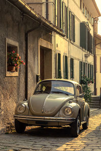 Vintage car on street against buildings