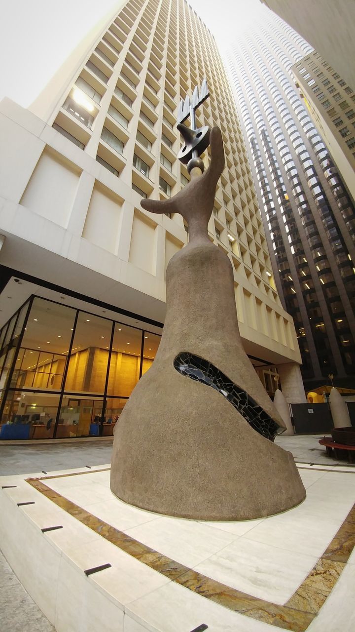 LOW ANGLE VIEW OF STATUE IN ILLUMINATED BUILDING