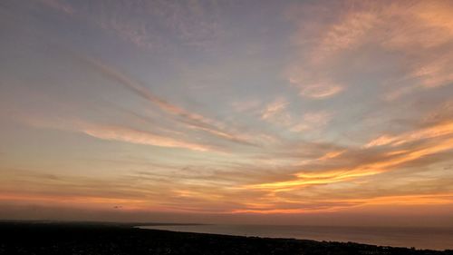 Scenic view of dramatic sky over sea during sunset