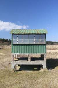 Built structure on field against sky