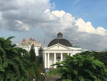 Buildings against cloudy sky