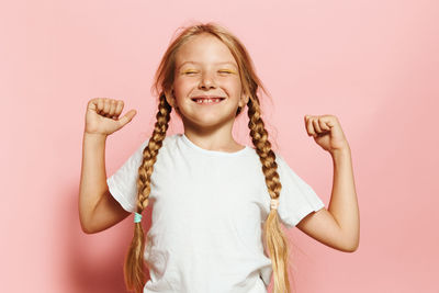 Portrait of young woman against white background