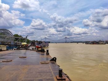 Bridge over sea against sky in city