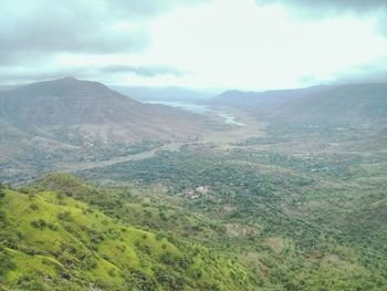 Scenic view of mountains against cloudy sky