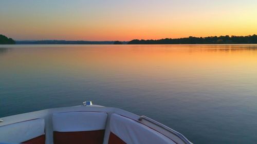 Boat in sea at sunset