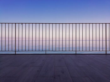 Empty road against clear sky at sunset