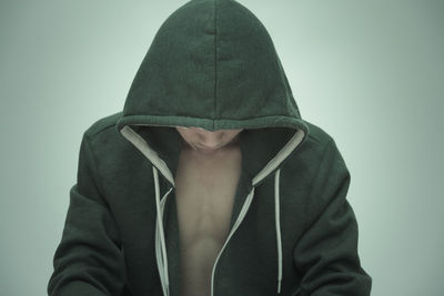 Young man against green background