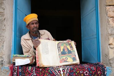 Full length of senior man in front of building