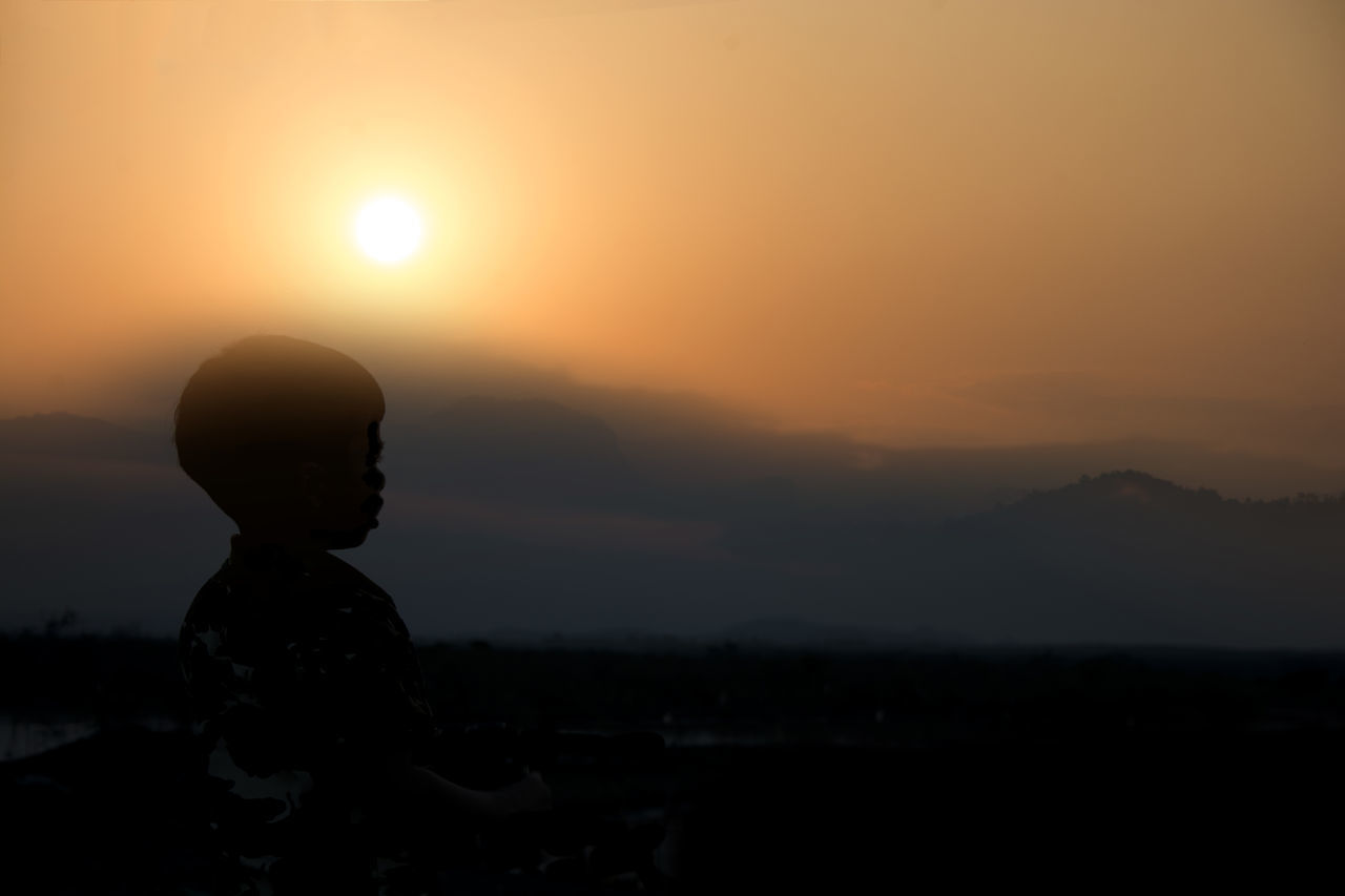 SILHOUETTE OF MAN AT SUNSET