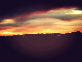 Scenic view of silhouette mountain against sky at sunset