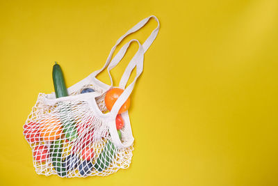 Close-up of yellow colored pencils on table against wall