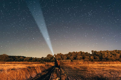 Scenic view of field against clear sky at night