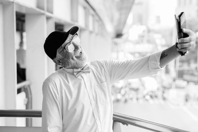 Man wearing hat standing outdoors