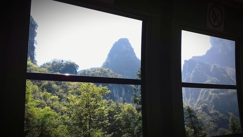 Scenic view of mountains seen through window