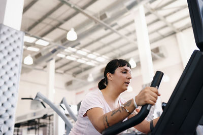 Low angle view of woman exercising at gym