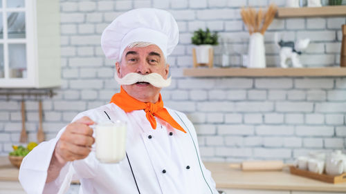 Portrait of man holding ice cream cone