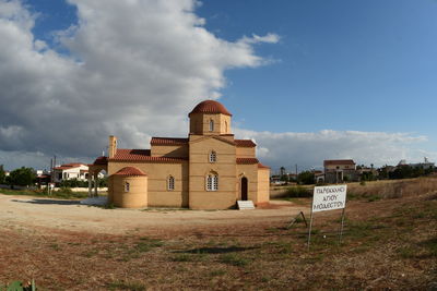 Houses on field against sky