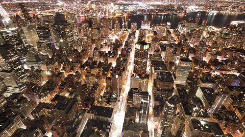 High angle view of illuminated modern buildings in city at night