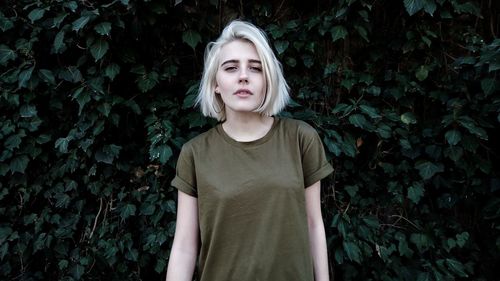 Portrait of young woman standing outdoors