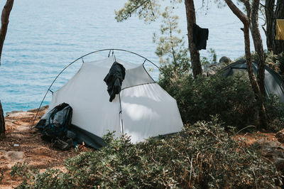 Tent vacationing relaxing traveler on the seashore. camping on a trip and hiking on the ocean or sea