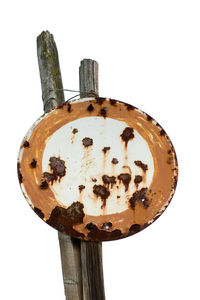 Close-up of old wooden post against white background